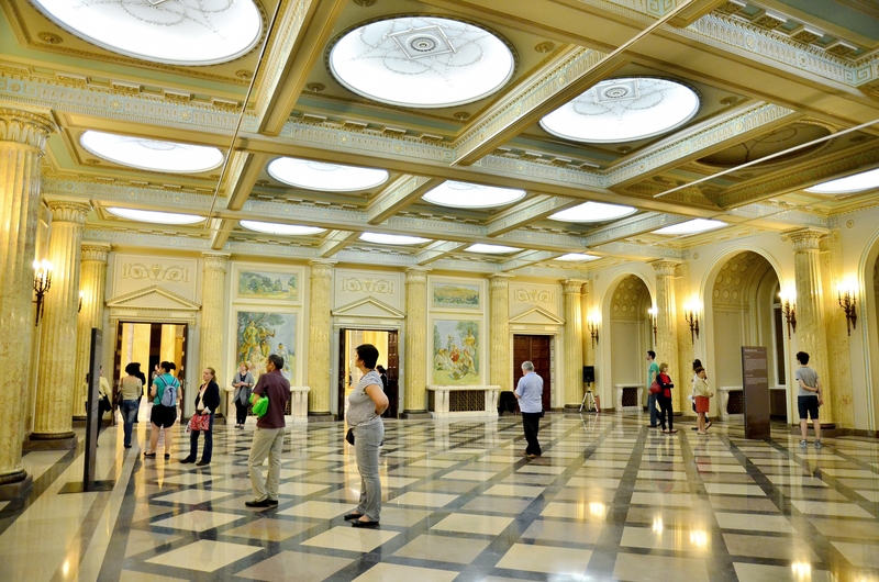 Visitors inside a fine art museum.